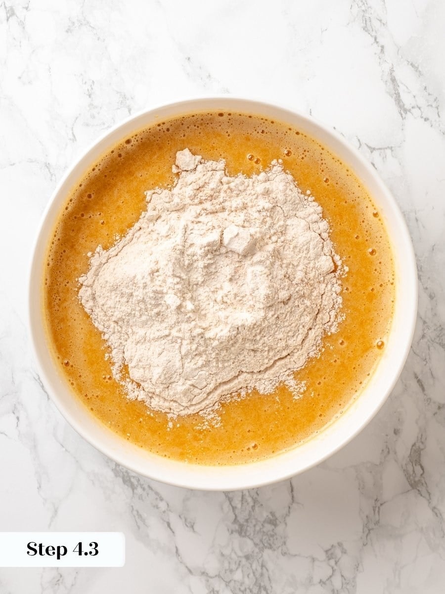 Folding flour in gently, just until combined, protects the pumpkin cake from turning dense or gummy.