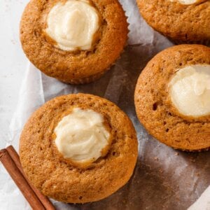 Clean edges where filling meets crumb show pumpkin cream cheese muffins baked without bleeding or browning.