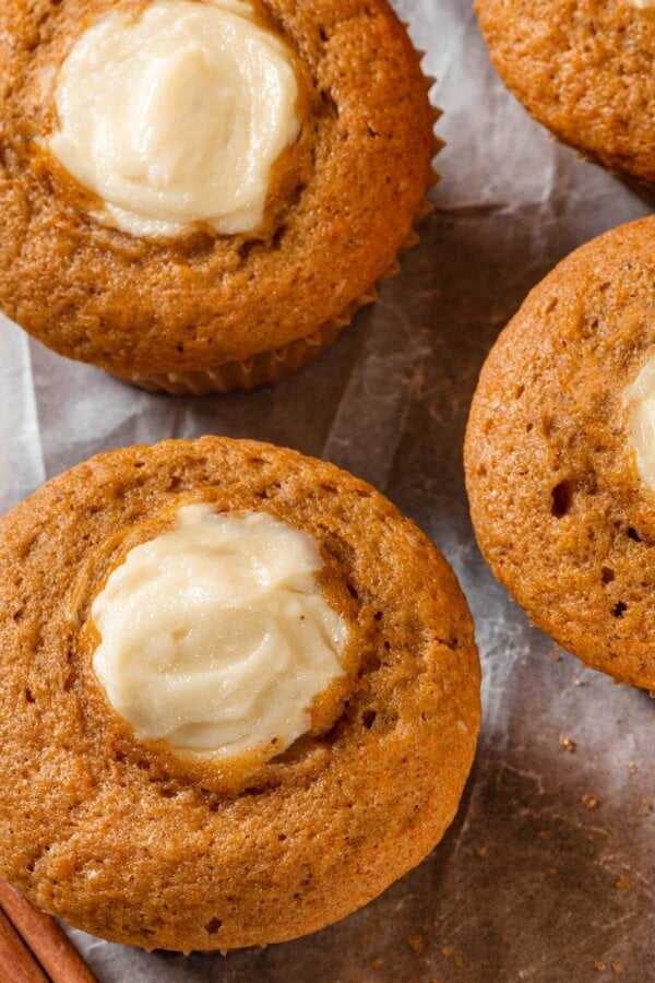 Clean edges where filling meets crumb show pumpkin cream cheese muffins baked without bleeding or browning.