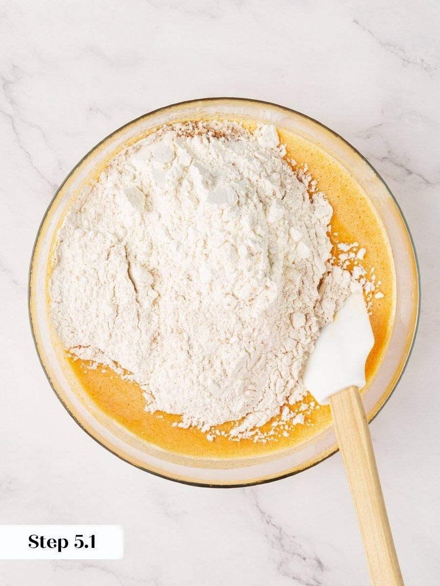 Switching from whisk to spatula here protects the tender texture of pumpkin cream cheese muffins.