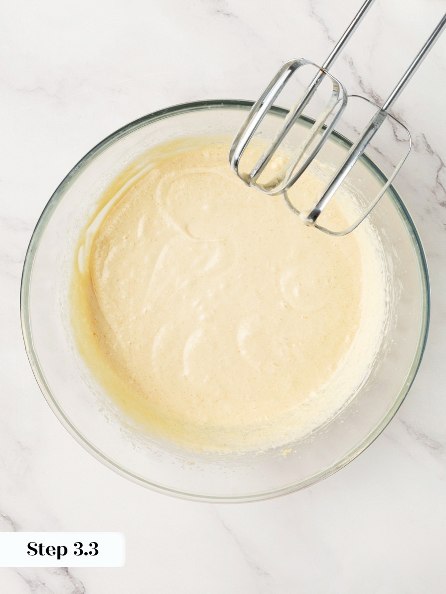 Adding eggs slowly keeps the emulsion intact in pumpkin cupcakes with cream cheese frosting.