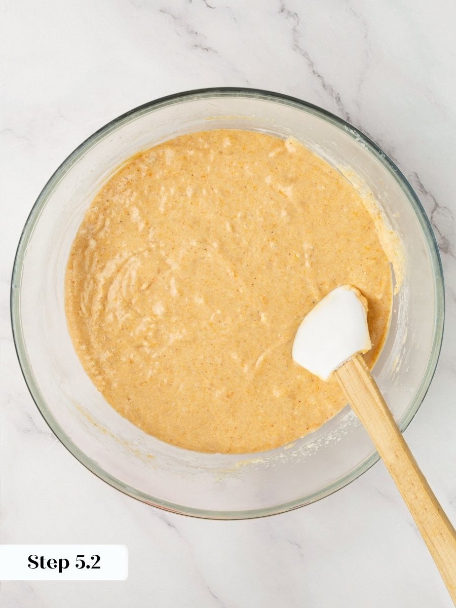Folding the last flour by hand keeps pumpkin cupcakes with cream cheese frosting tender.