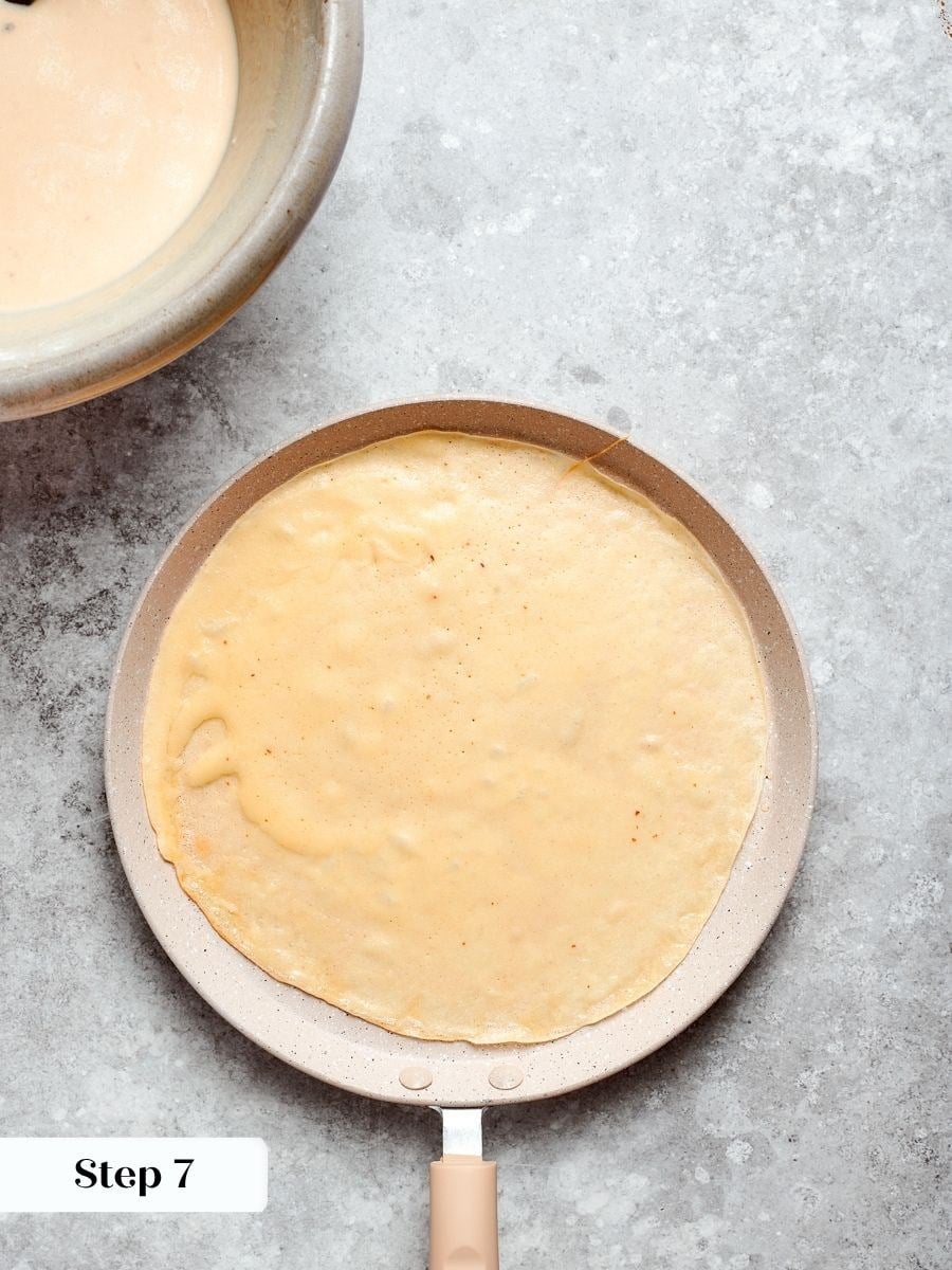 Swirling quickly matters because buckwheat crepes begin setting within seconds of touching the hot pan.