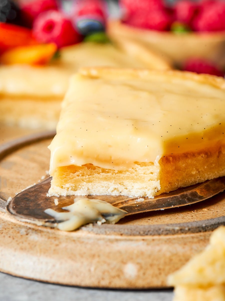 Cut cleanly, a tart built on frangipane holds every layer in its own band.