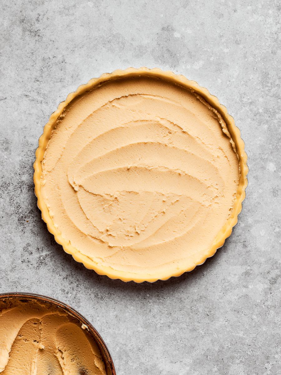A thin even layer is all a tart needs; frangipane rises as it bakes.