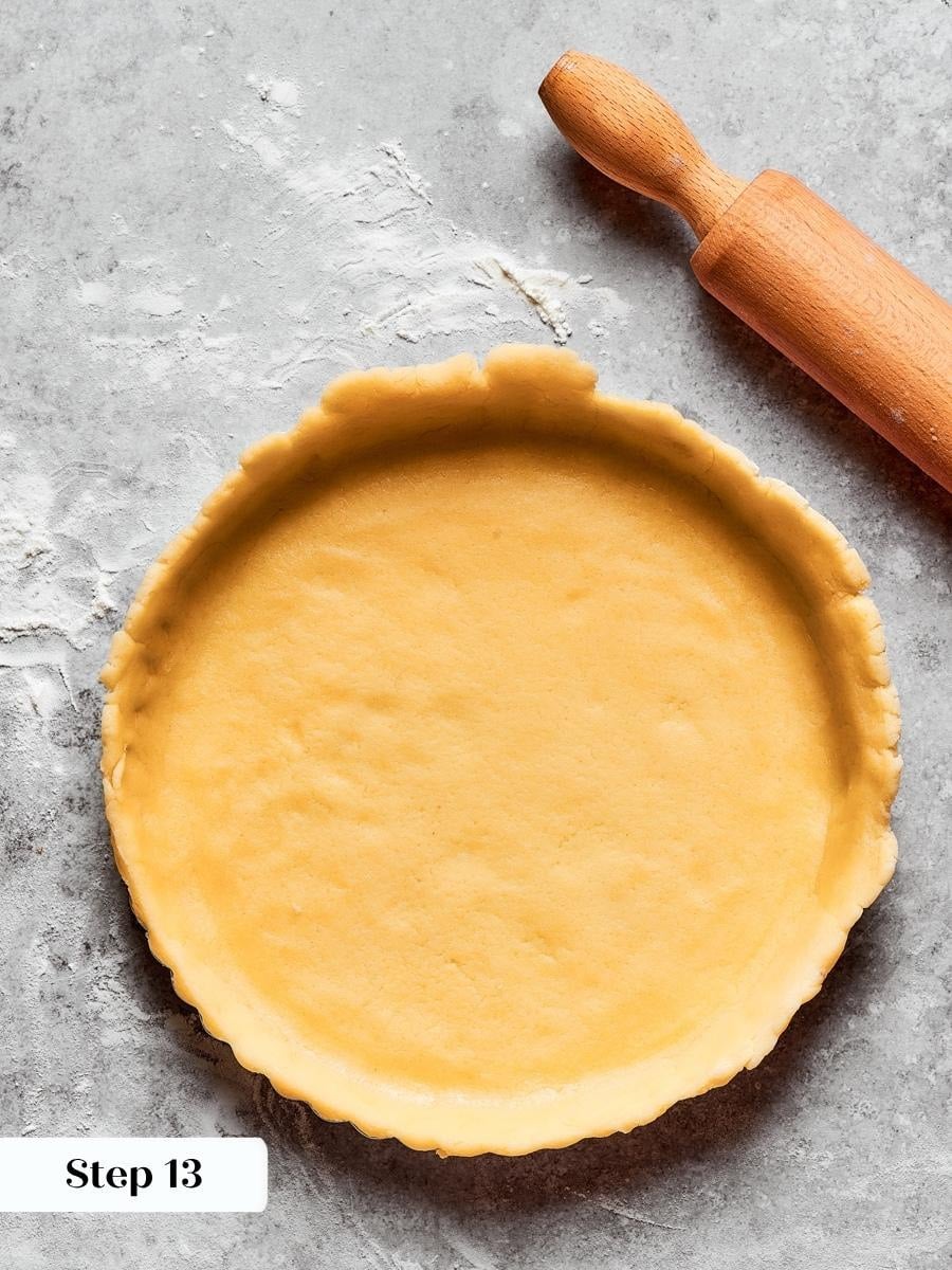 Docking the base with a fork stops the fruit tart crust puffing during its bake.