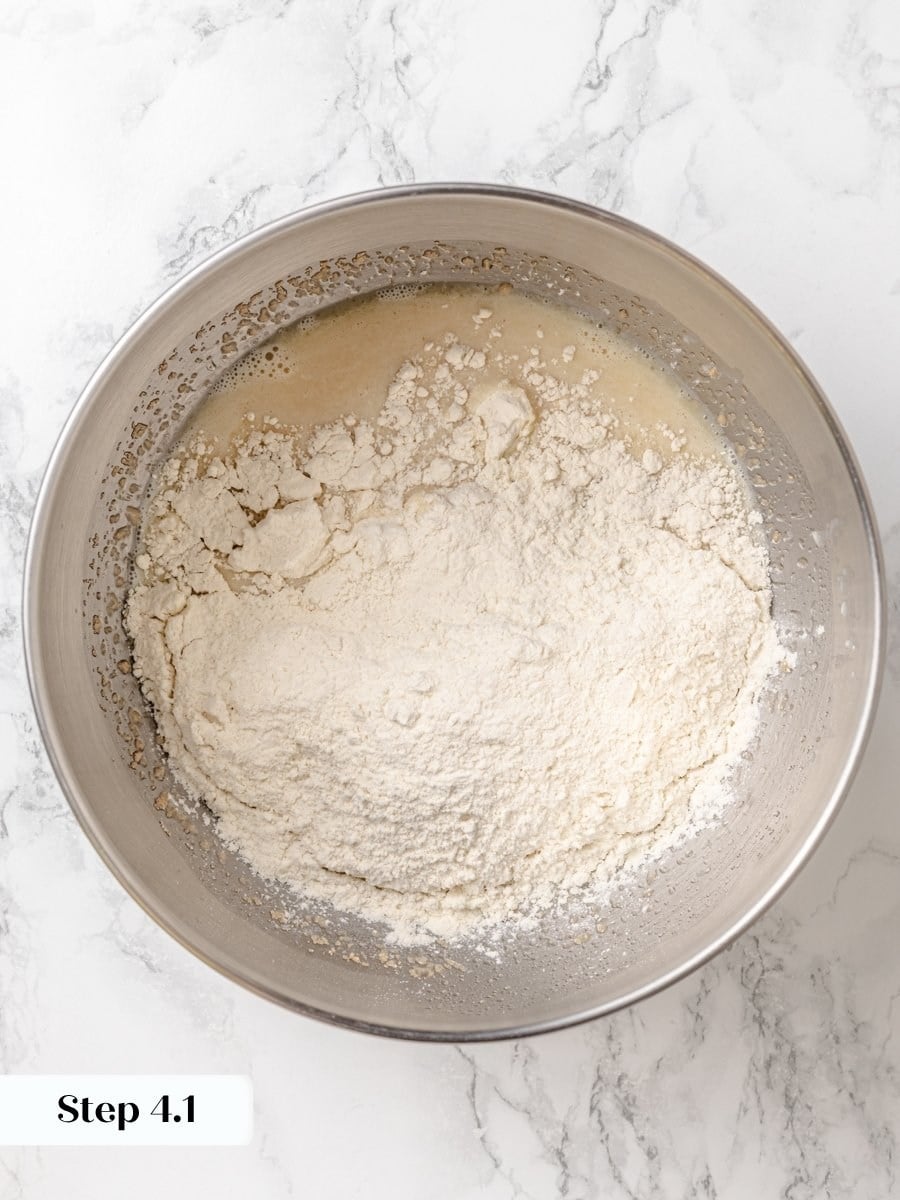 Adding flour in two stages keeps the Krispy Kreme donut dough from clumping around the paddle.