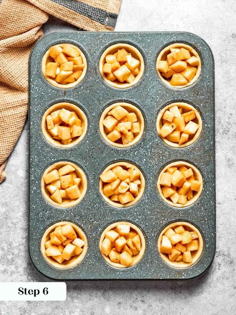Filling generously matters because it cooks down, leaving mini apple pies with plenty of fruit.