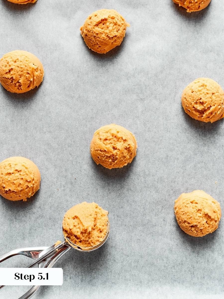 Squeezing each portion firmly compacts the crumbly dough that chewy peanut butter cookies rely on.
