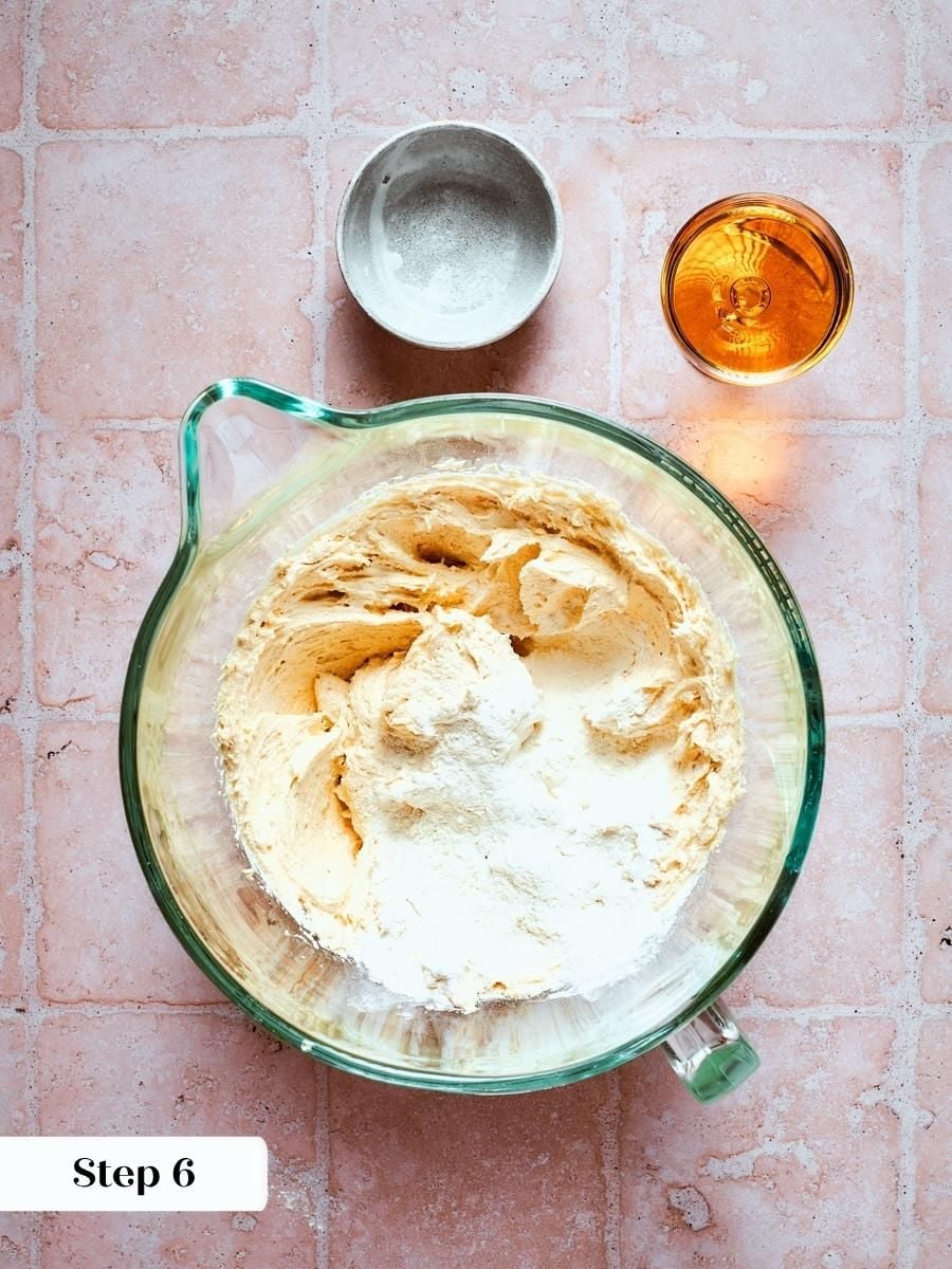 Folding flour into the almond base gives french apple cake its sturdy yet tender crumb structure.