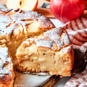 This wider framing around french apple cake being sliced lets the autumn produce and warmth breathe.