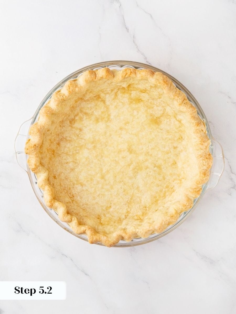 Remove the weights once the crust looks fully matte so the snickers pie shell stays crisp.