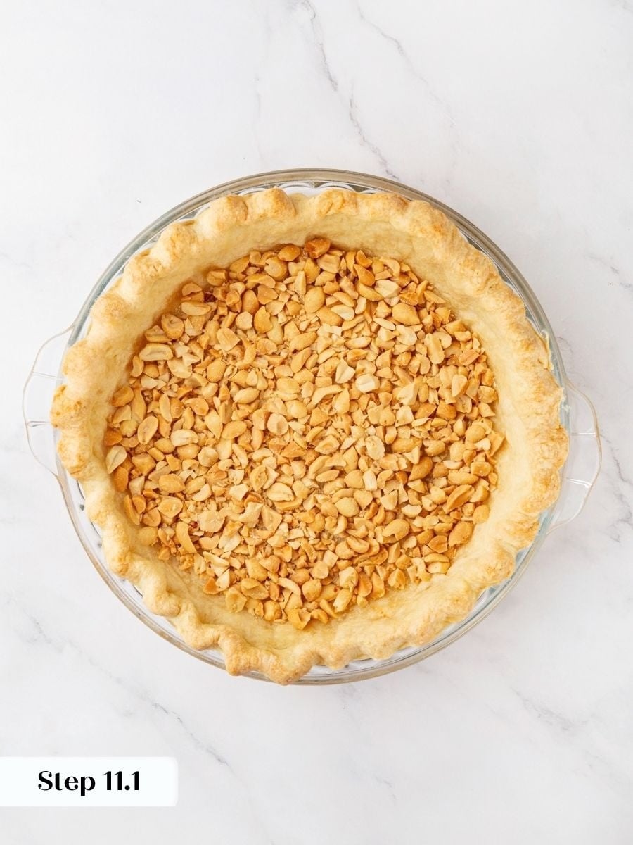 Peanuts form the crunchy first layer of this snickers pie, the foundation of every bite.