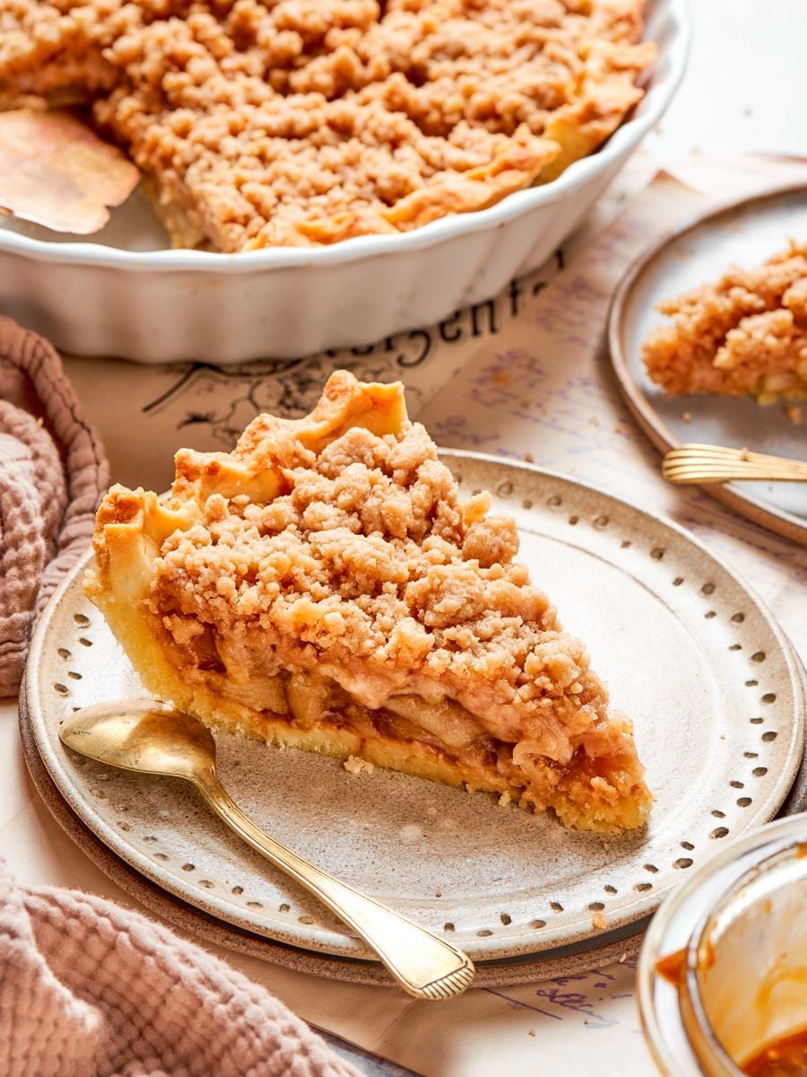 Rested twenty minutes after baking, a caramel apple tart slice holds its shape when served.