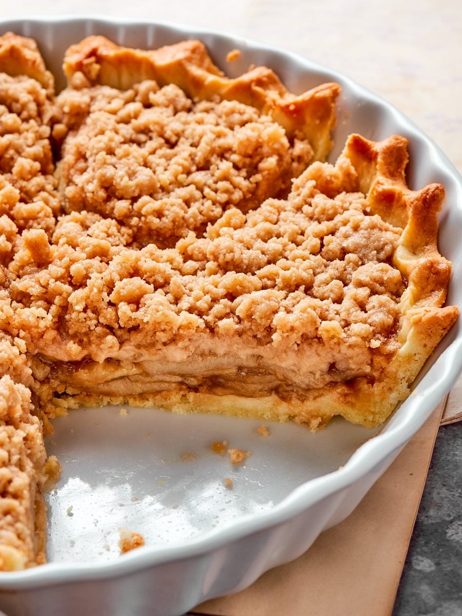 Clean layers of crust, caramel, apples, and streusel show how neatly this caramel apple tart slices.