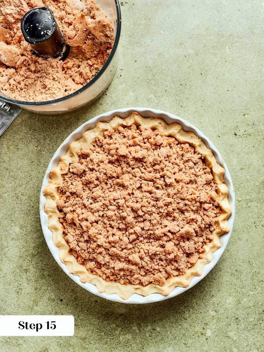 Streusel crumbled over every bit of apple finishes the caramel apple tart before baking.