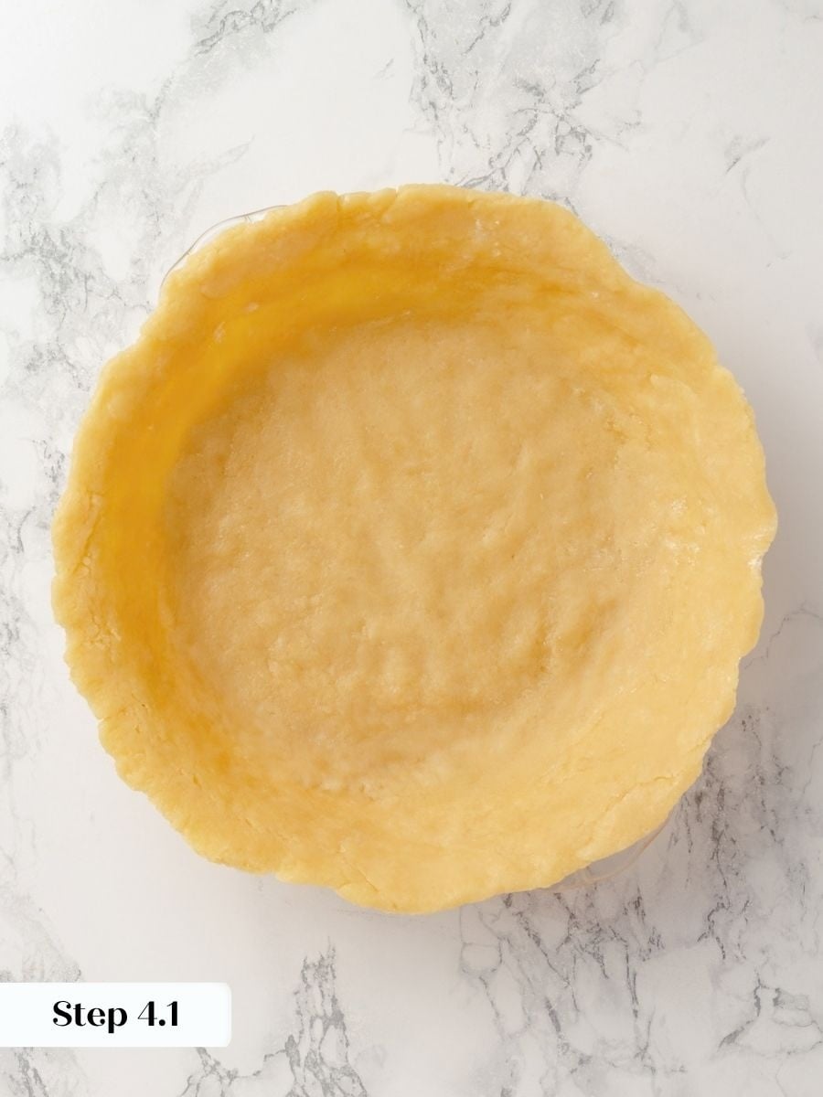 Pressing the cold dough gently into the corners helps the chocolate chess pie shell resist shrinking.