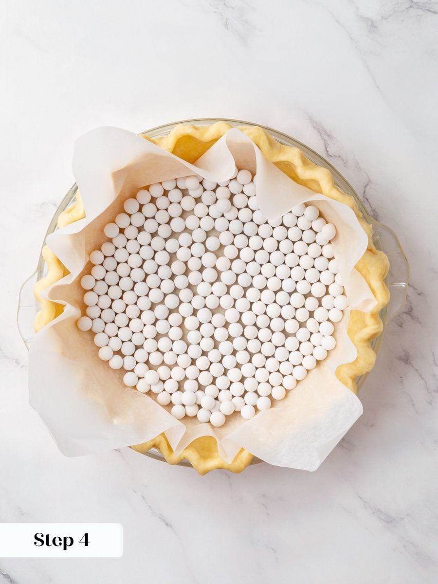 Weighing down the shell keeps the chocolate fudge pie crust flat and evenly shaped.