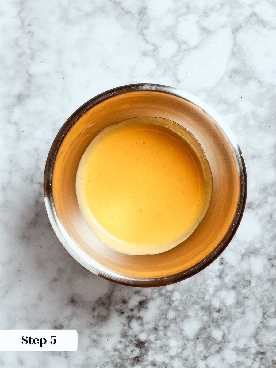 Straining removes the pod and any cooked egg so the finished crème anglaise pours silky smooth.