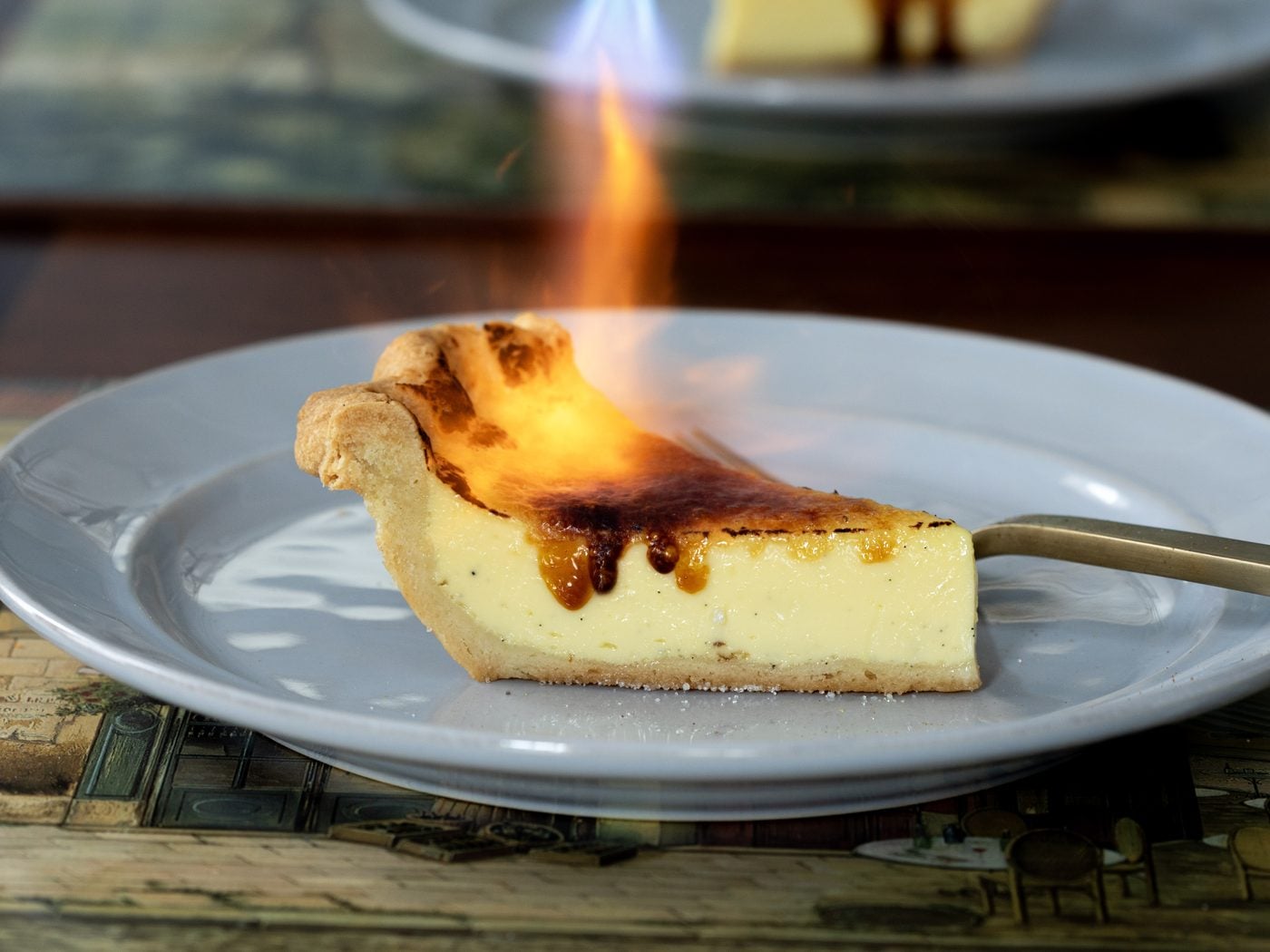 Torching the sugar on a slice of crème brûlée pie