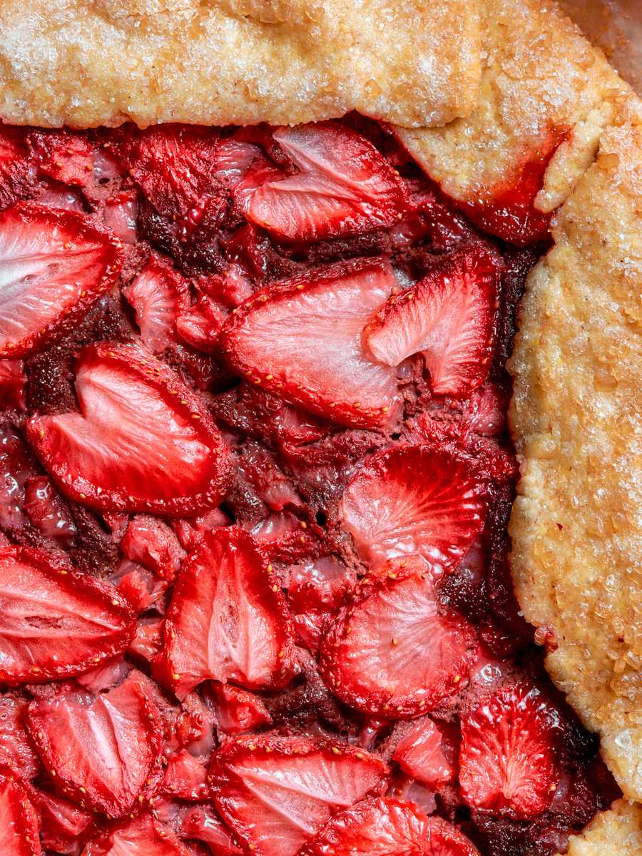 Sparkling sugar on the border adds crunch against the soft, juicy center of this strawberry galette.