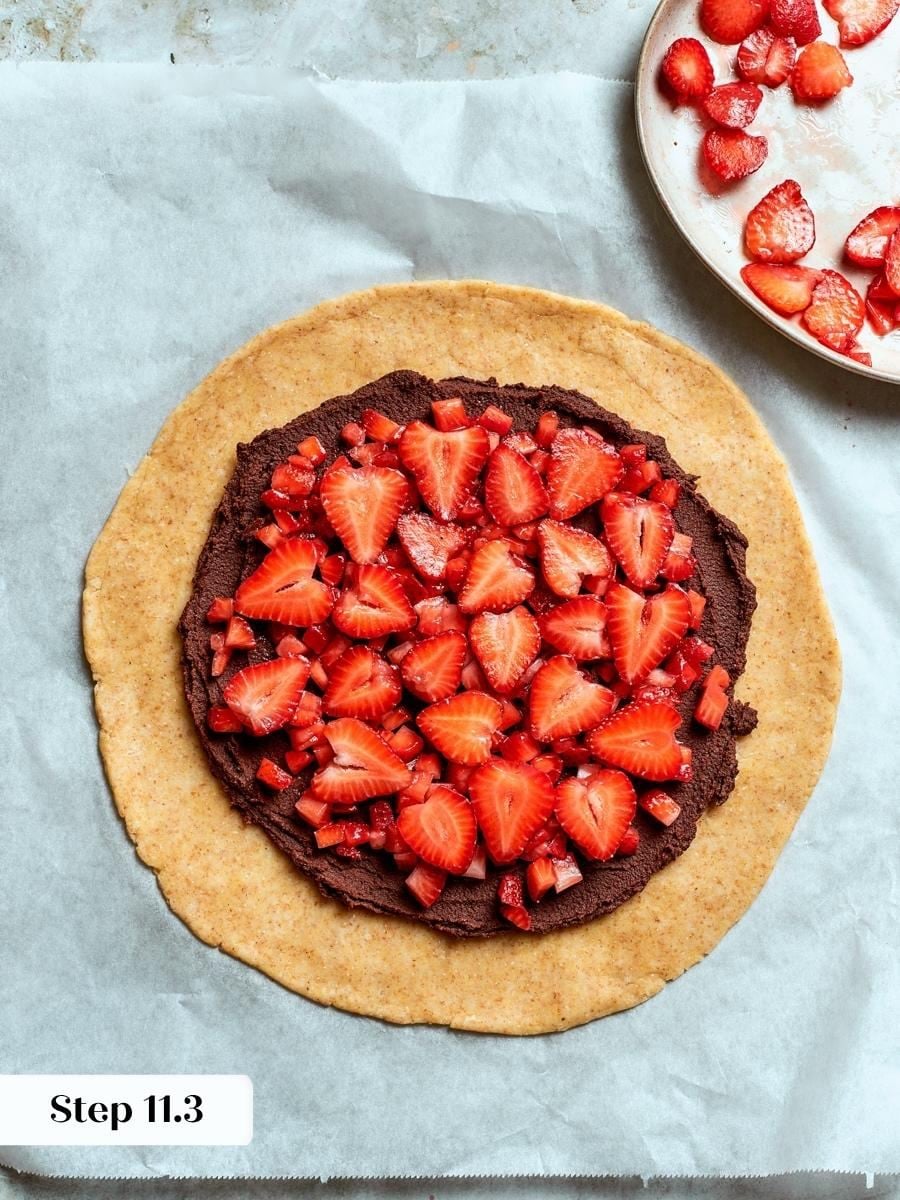 Two cuts of fruit, diced underneath and sliced on top, define this strawberry galette.