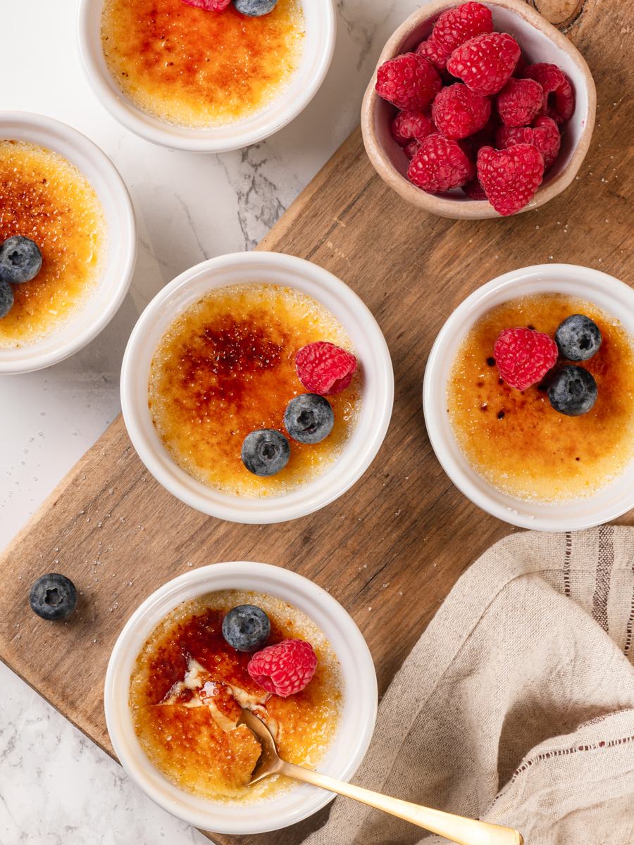 Add fresh berries just before serving so vanilla creme brulee keeps its crisp caramel crunch.