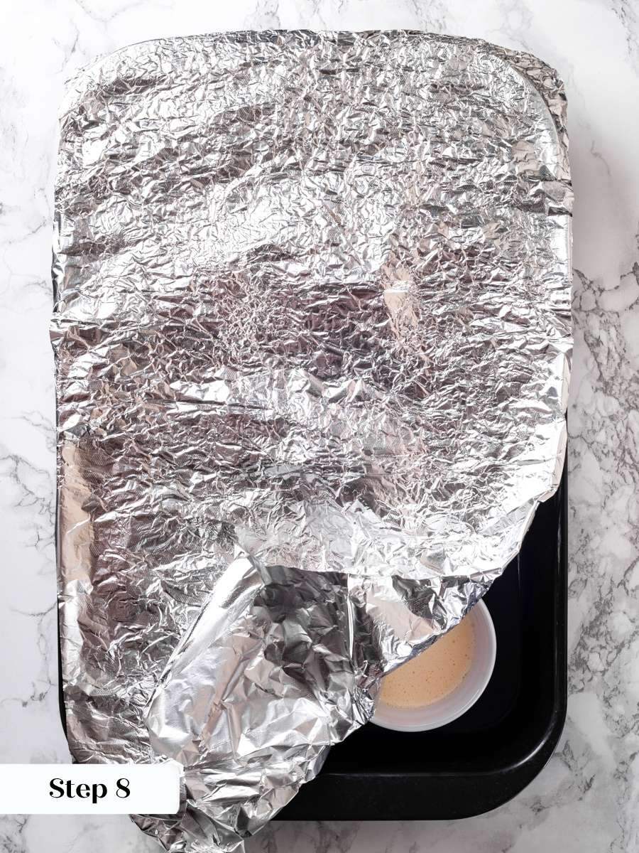 A tight foil seal keeps steam in, so vanilla creme brulee bakes silky without a skin.