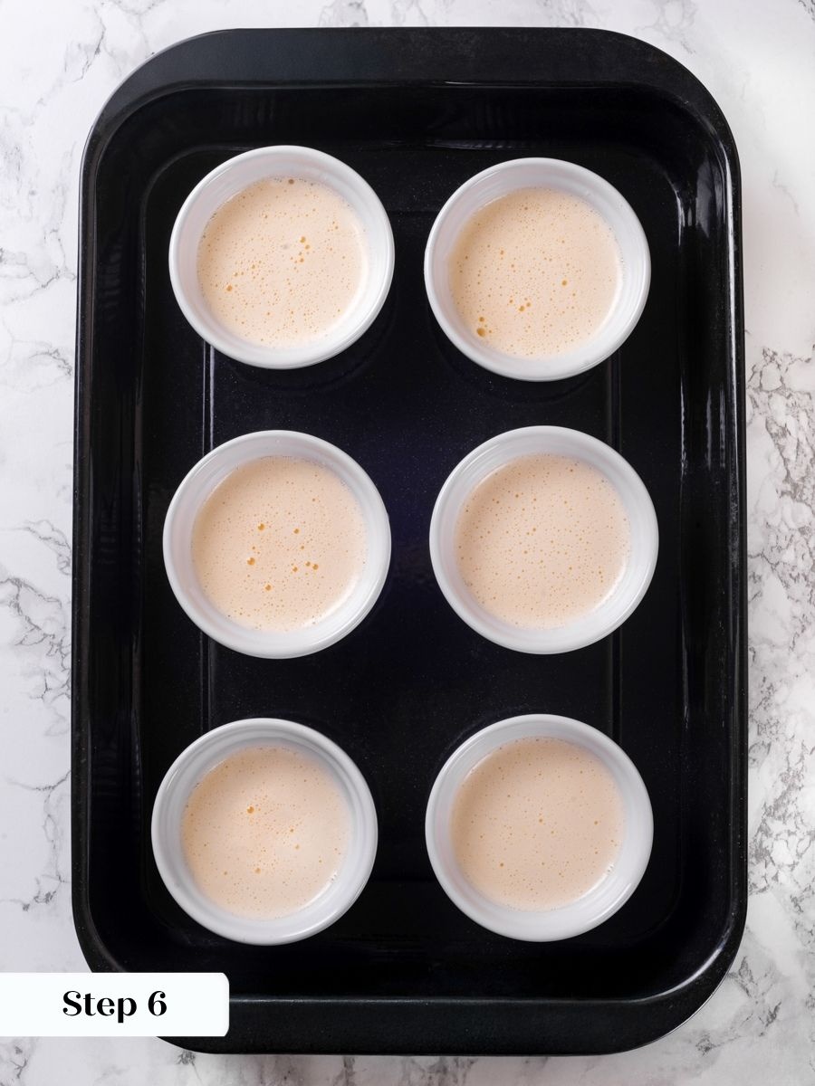 Filling each ramekin to the same level helps every vanilla creme brulee bake evenly.